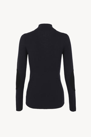 Cano, blue turtleneck jumper