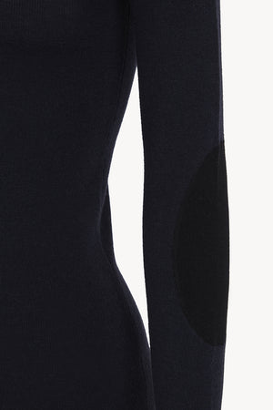 Cano, blue turtleneck jumper