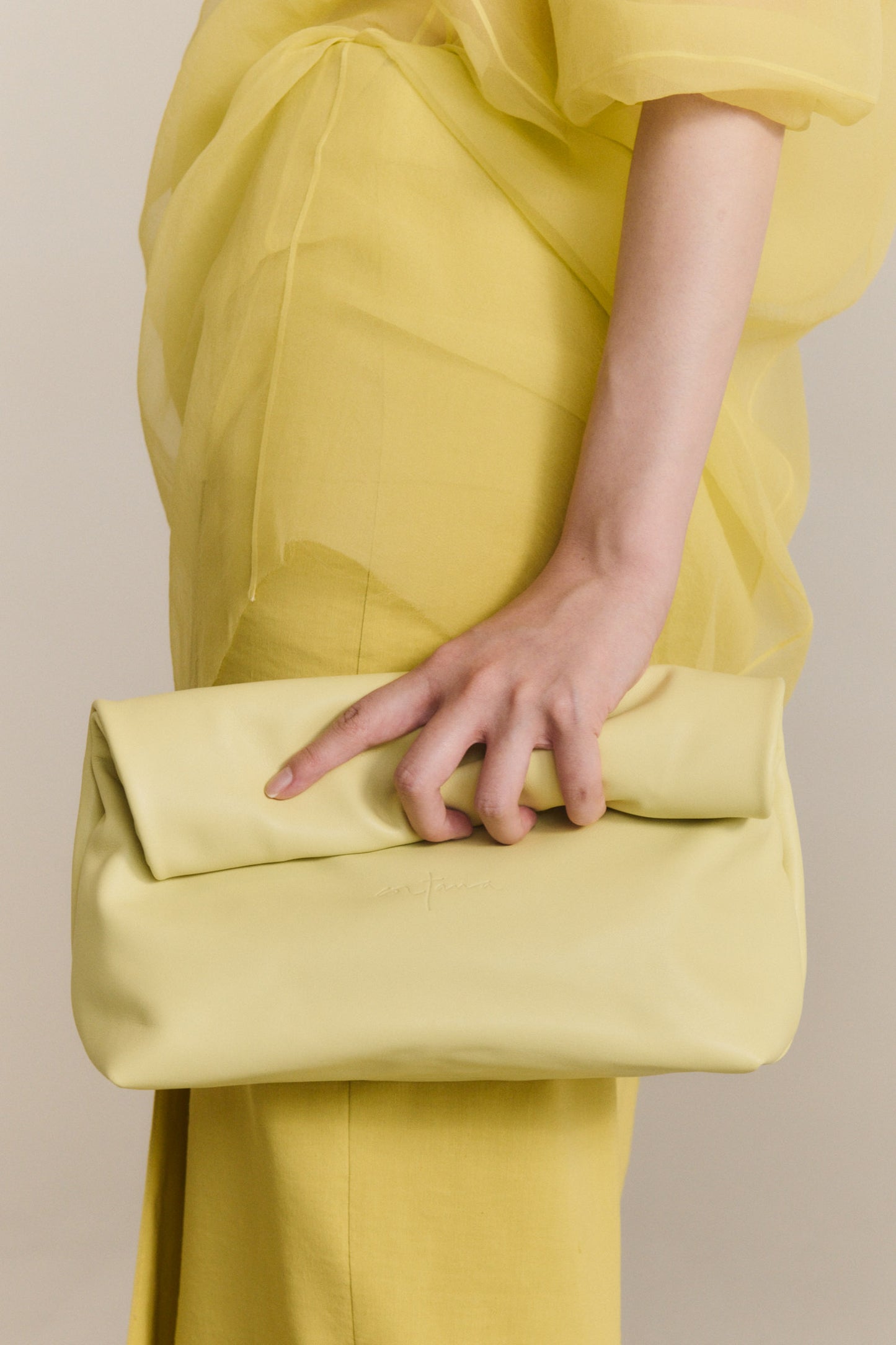 Delhi S, pale canary leather clutch