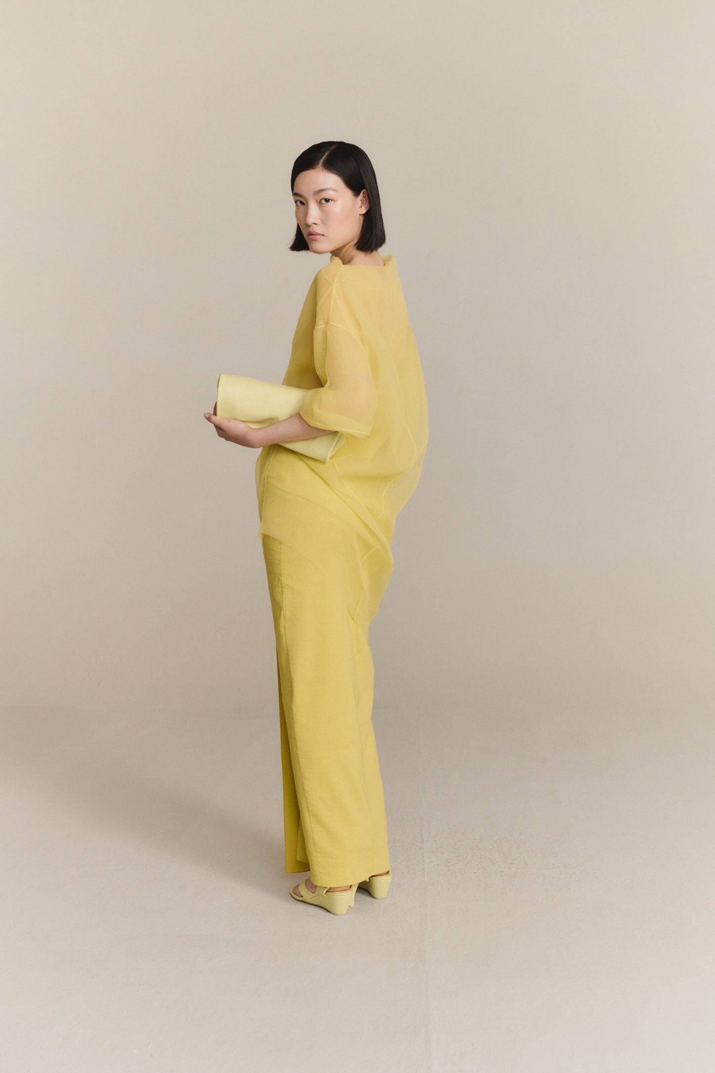 Delhi S, pale canary leather clutch