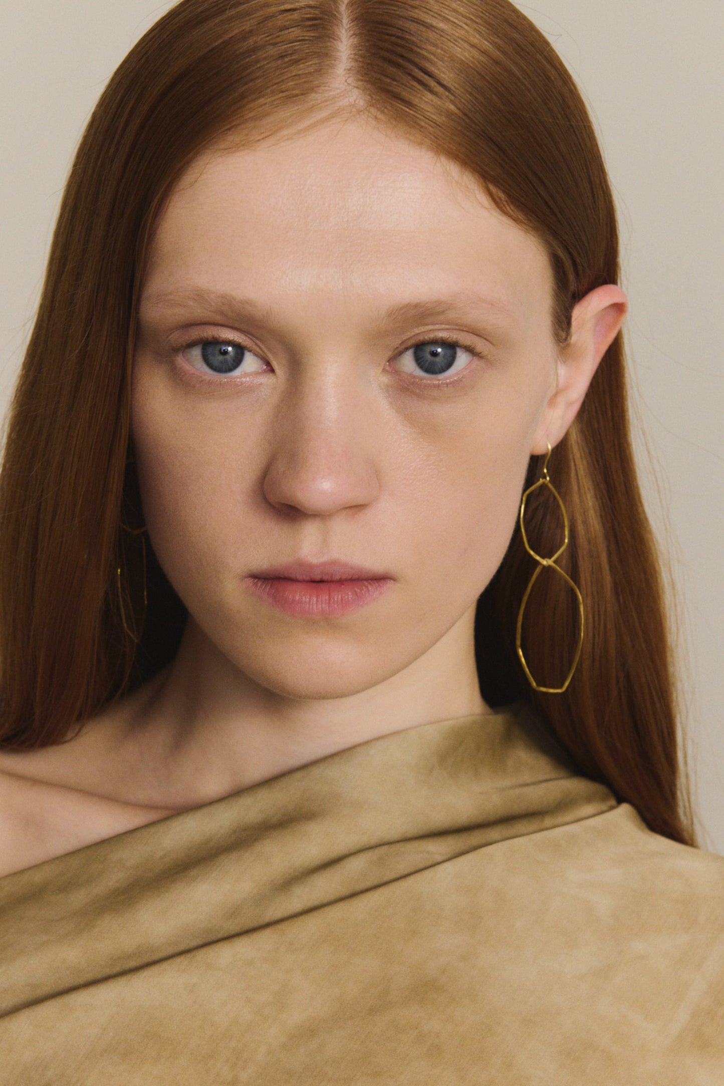 Irus L, gold earrings