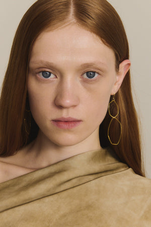 Irus L, gold earrings