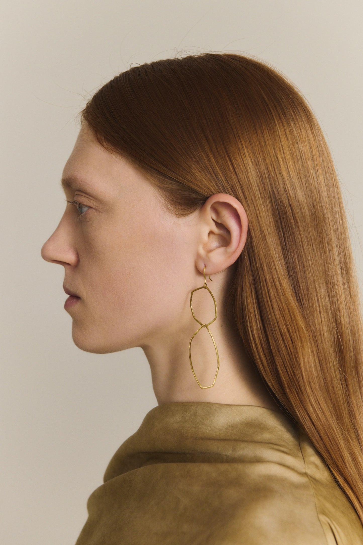 Irus L, gold earrings