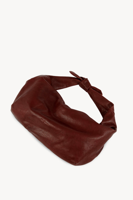 Jin L, dark maroon leather fanny pack